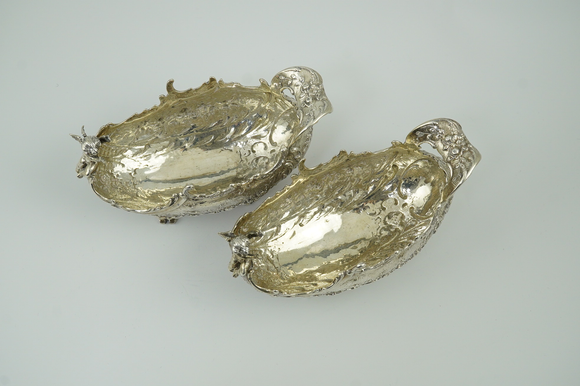 A pair of late 19th century German Hanau ornate embossed silver oval sweetmeat bowls